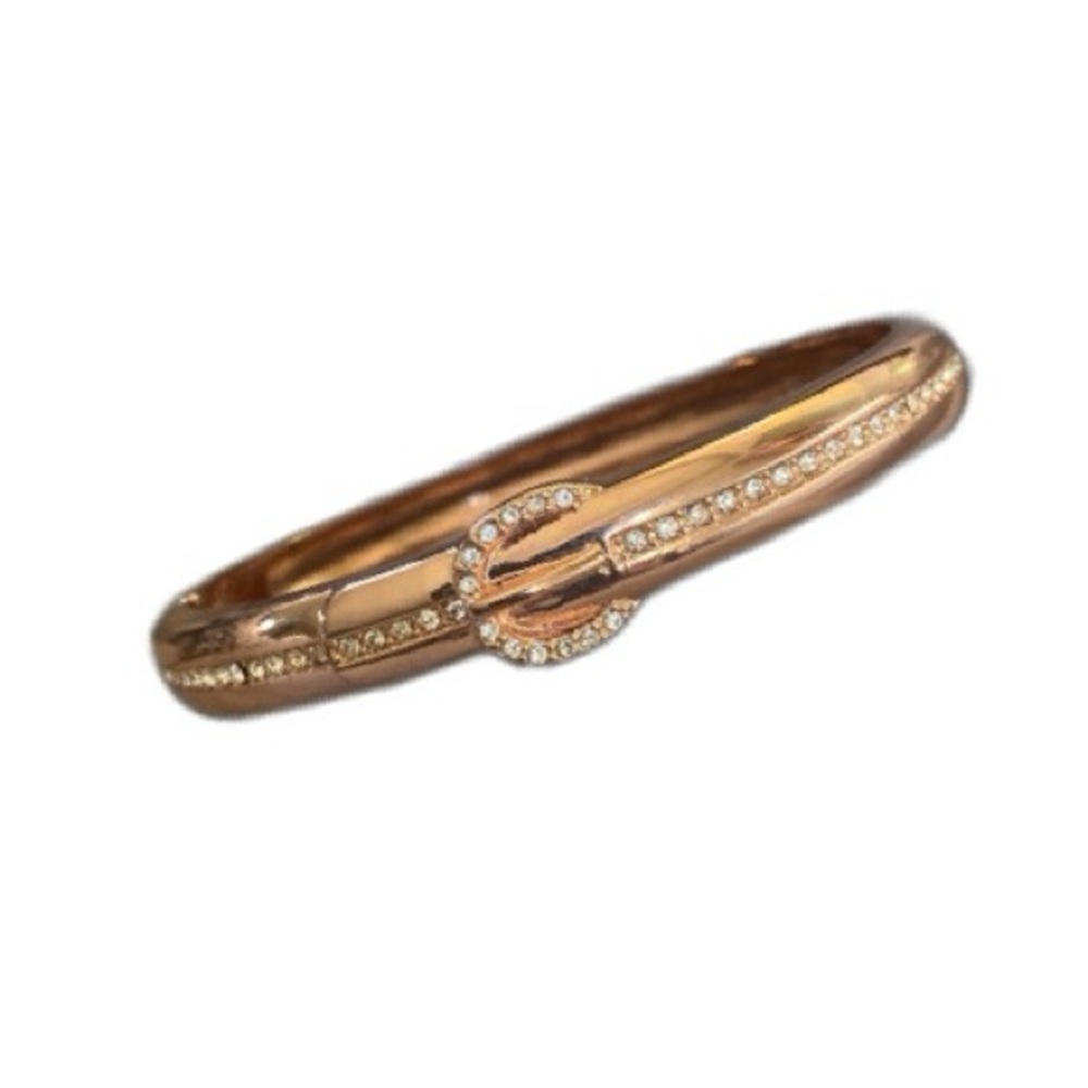 Rose gold tones clamp bracelet. Signed
